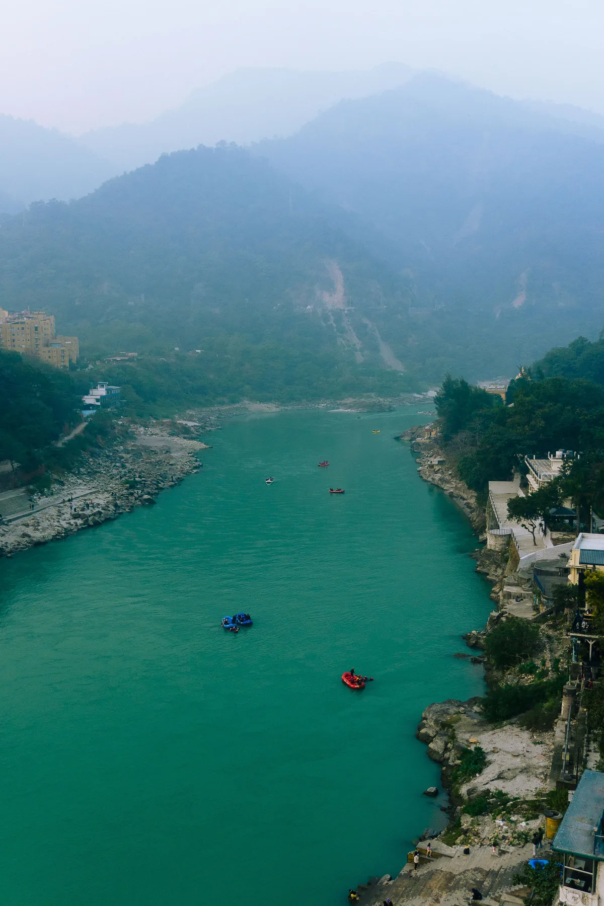 A river running between forested hills near Rishikesh, seen from above.
