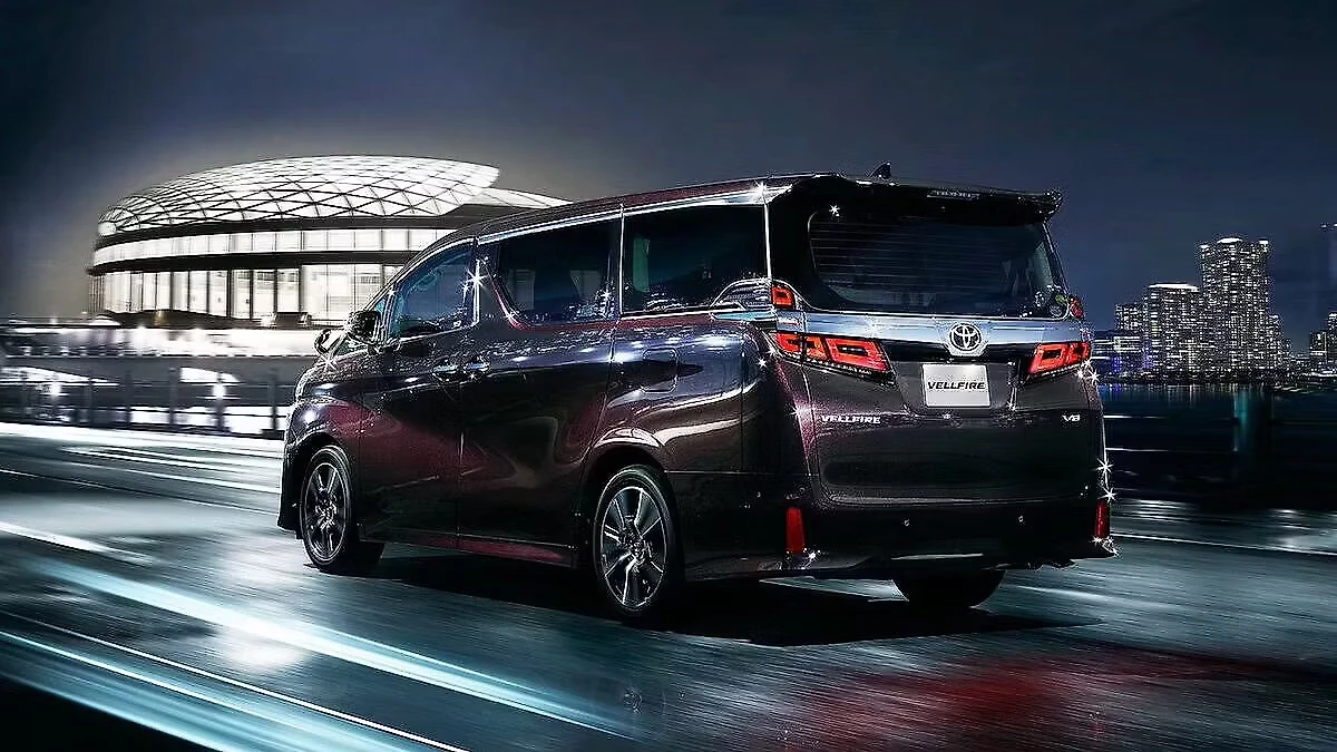 Toyota Vellfire travelling through the city at night.